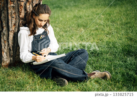 Girl Drawing in Summer Park. Relax lifestyle portrait Girl Drawing in Summer Park. Relax lifestyle portrait 133825715