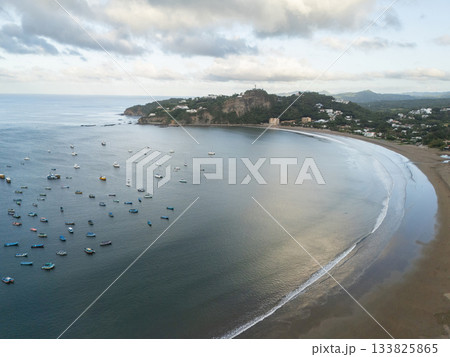 Beautiful shoreline with fishing boats in scenic coastal village Beautiful shoreline with fishing boats in scenic coastal village 133825865