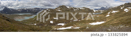 Hiking in the stunning landscape of Jotunheimen National Park near Bygdin Mountain Hotel towards Synshorn peak 133825894