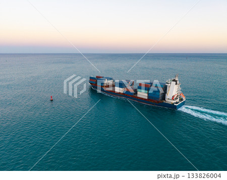 Commercial shipping. Cargo ship in sea, aerial view. Freight container loaded on cargo vessel. Aerial cargo ship with container. Cargo business. Container ship. Shipping logistics. Sailing the sea 133826004