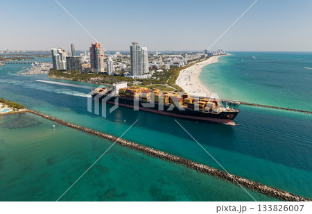 Commercial shipping. Cargo ship in sea, aerial view. Freight container loaded on cargo vessel. Aerial cargo ship with container. Cargo business. Container ship. Shipping logistics. Sailing the sea Commercial shipping. Cargo ship in sea, aerial view. Freight container loaded on cargo vessel. Aerial cargo ship with container. Cargo business. Container ship. Shipping logistics. Sailing the sea 133826007