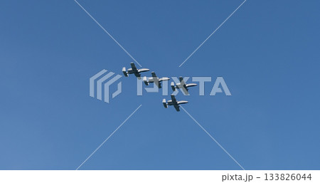 Military air force fighter jet airplane in full flight against blue sky. Four fighter jet in V shape in sky. Squadron. Air Force Day. Aircraft squadron on a mission. US air force 133826044