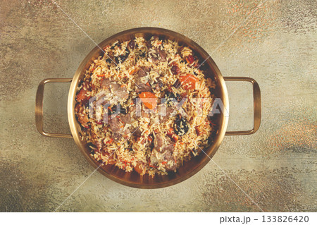 rice dish with meat and dried fruits, in a large pot, pilaf, homemade, no people rice dish with meat and dried fruits, in a large pot, pilaf, homemade, no people 133826420