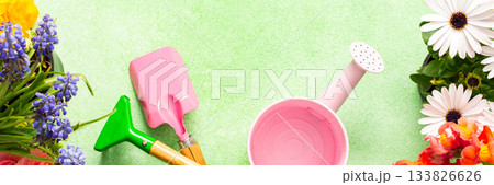 A bright and lively balcony showcases a variety of spring flowers in full bloom. Gardening tools are arranged artfully among the colorful petals, inviting creativity and joy., banner A bright and lively balcony showcases a variety of spring flowers in full bloom. Gardening tools are arranged artfully among the colorful petals, inviting creativity and joy., banner 133826626