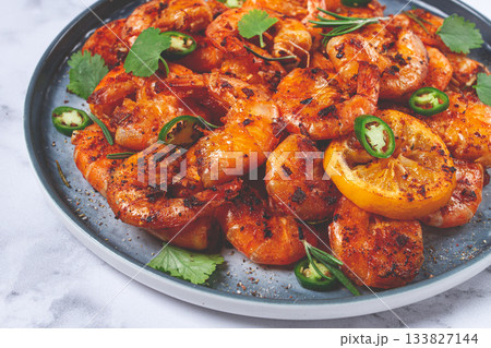 grilled shrimp, unpeeled, headless, with spices, on a marble table, homemade, no people, 133827144