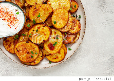 Crispy potato slices, with parmesan cheese and spices, fried in the oven, homemade, no people, Crispy potato slices, with parmesan cheese and spices, fried in the oven, homemade, no people, 133827151