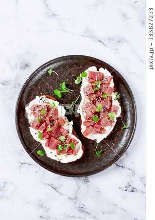 sandwiches, rye bread with cream cheese, sliced tuna fillet with herbs, breakfast on a black plate, homemade, sandwiches, rye bread with cream cheese, sliced tuna fillet with herbs, breakfast on a black plate, homemade, 133827213