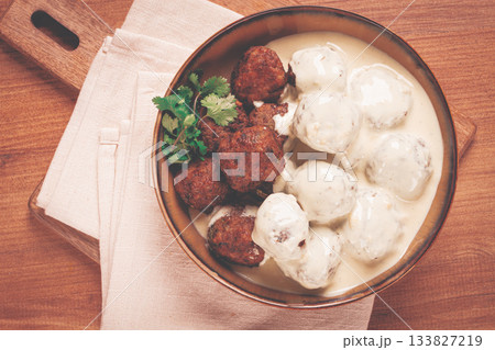 Swedish meatballs in cream sauce, plate on a wooden table, homemade, no people, Swedish meatballs in cream sauce, plate on a wooden table, homemade, no people, 133827219