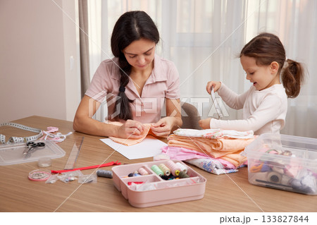 Mother and little daughter bonding, learning craft skills, and creating handmade items 133827844