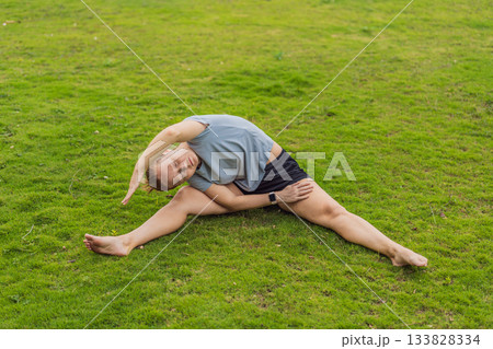 Unaltered woman exercising in a park, enjoying movement, fresh air and a healthy outdoor routine. Concept of fitness, wellbeing, positive lifestyle, energy, self-care and everyday outdoor activity in Unaltered woman exercising in a park, enjoying movement, fresh air and a healthy outdoor routine. Concept of fitness, wellbeing, positive lifestyle, energy, self-care and everyday outdoor activity in 133828334