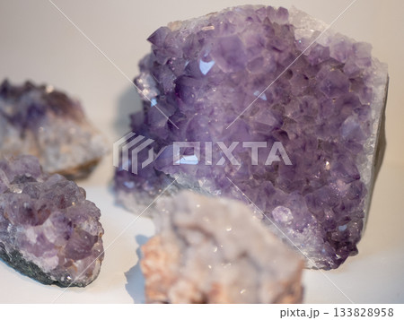 Cluster of natural amethyst crystals. Purple quartz formations with sharp facets and translucent glow 133828958