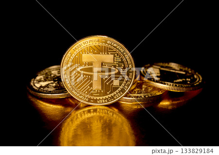 Tether USDT cryptocurrency and gold coins. Tether USDT cryptocurrency and gold coins. 133829184