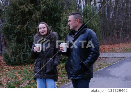 drink coffee in paper cups daughter caring for father teenagers, adult communication, good family relationships, support 133829462