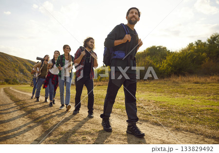 Group of friends walking on a rural trail during a trekking holiday in the countryside 133829492