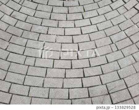 Gray sidewalk background, tiles laid in a curved, semi-circular pattern Gray sidewalk background, tiles laid in a curved, semi-circular pattern 133829528