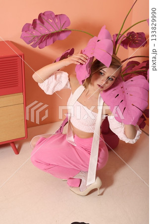 Tranquil woman reclines on ground surrounded by vintage decor Tranquil woman reclines on ground surrounded by vintage decor 133829990