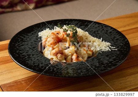 Seafood pasta with herbs, Creamy seafood linguine topped with cheese and fresh herbs served warm Seafood pasta with herbs, Creamy seafood linguine topped with cheese and fresh herbs served warm 133829997