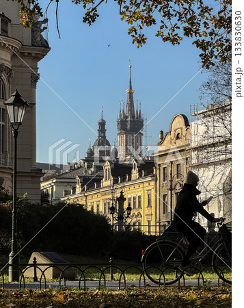 Historic European City Street With Iconic St Mary Church towers, Bicyclist passing by, Old Town Krakow, Poland 133830630