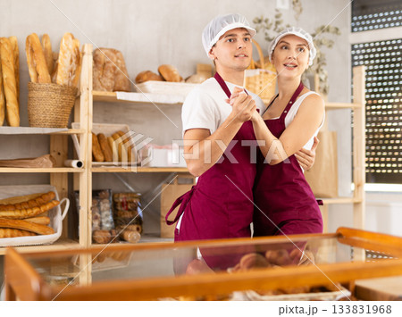 Young sellers standing in bake house, ready to greet customers 133831968
