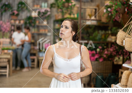 Female shopper choosing products in gardening supply store Female shopper choosing products in gardening supply store 133832030