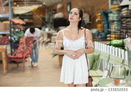 Female shopper choosing products in gardening supply store 133832033