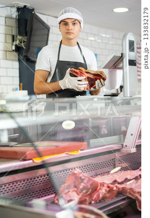 Guy seller works in specialized butcher shop Guy seller works in specialized butcher shop 133832179