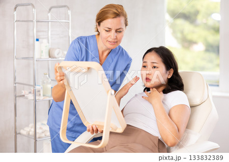 Asian woman listening to professional medicine worker 133832389