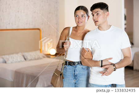 Couple man and woman looking around in bedroom department Couple man and woman looking around in bedroom department 133832435