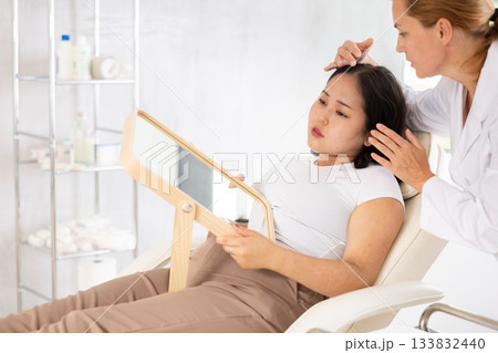Female doctor giving consultation about injection for lips to female patient in aesthetic clinic Female doctor giving consultation about injection for lips to female patient in aesthetic clinic 133832440