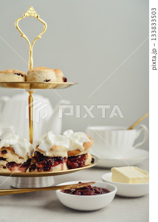 Golden two-tiered stand  with homemade scones 133833503