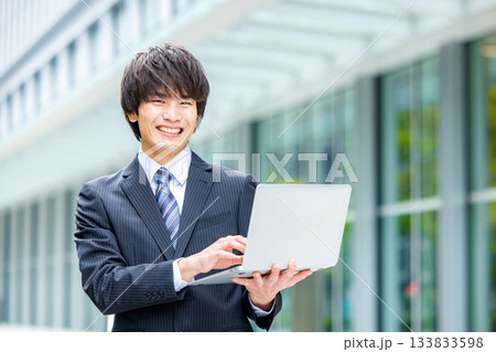 オフィスでノートパソコンを持つビジネスマン 133833598