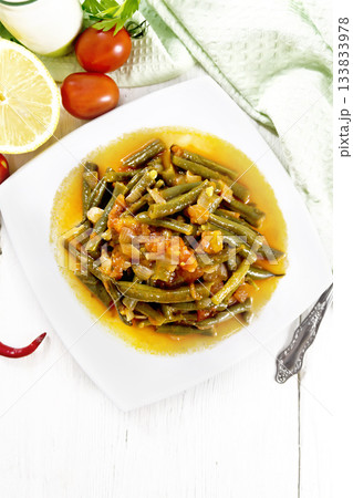 Beans green with vegetables in plate on light board top Beans green with vegetables in plate on light board top 133833978