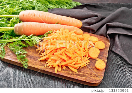 Carrots grated on dark board 133833991