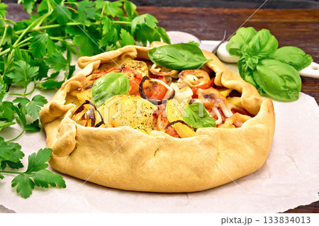 Galette of potato and tomato on board Galette of potato and tomato on board 133834013