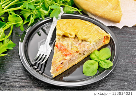 Galette with minced meat and peppers in plate on wooden board Galette with minced meat and peppers in plate on wooden board 133834021
