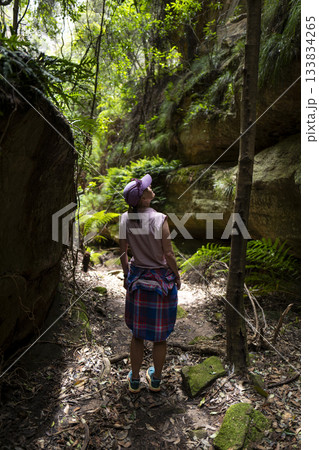 Rear view of female hiker exploring canyon at Ferntree Gully 133834265