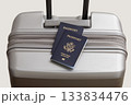 US passports on gray suitcase 133834476