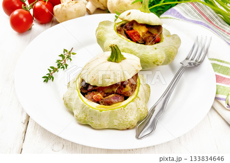 Patissons stuffed with liver in plate on board 133834646