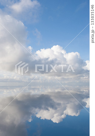 Cumulus clouds reflected on infinity edge pool Cumulus clouds reflected on infinity edge pool 133835146