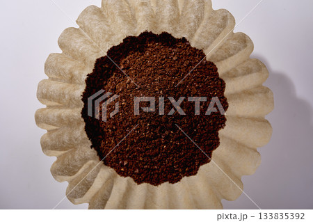 Overhead view of grounded coffee in paper filter 133835392