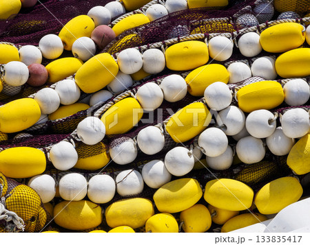 Close-up of fishing nets with yellow and white buoys 133835417