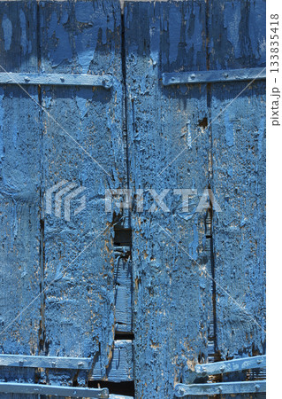 Close-up of weathered blue wooden shutters 133835418