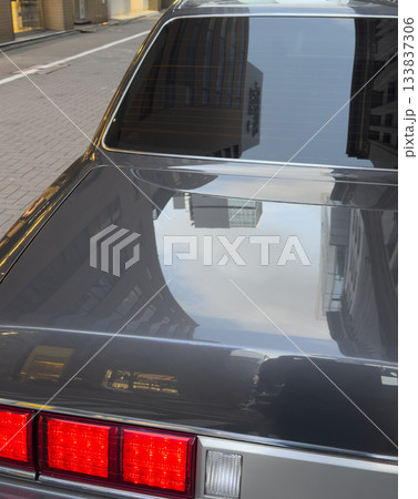 Urban reflections on black car and window 133837306