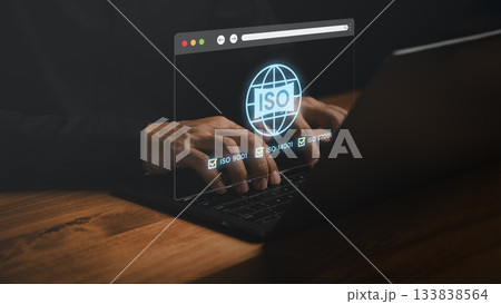 Close-up of hands typing on laptop with glowing ISO certification icons, representing quality management, standards compliance, business certification, and international regulations for organizations. Close-up of hands typing on laptop with glowing ISO certification icons, representing quality management, standards compliance, business certification, and international regulations for organizations. 133838564