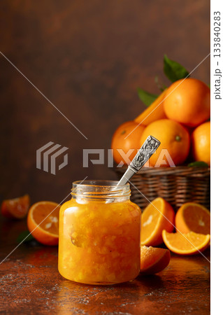 Orange jam and fresh fruits on a brown vintage table. 133840283