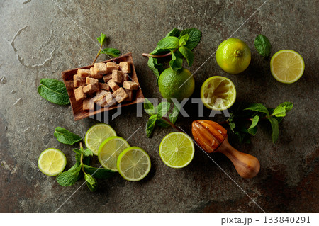 Wooden citrus squeezer and ingredients for making summer refreshing drinks. Wooden citrus squeezer and ingredients for making summer refreshing drinks. 133840291