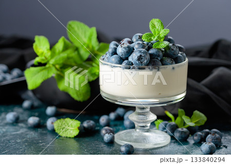 Panna cotta with fresh blueberries in a clear bowl. Panna cotta with fresh blueberries in a clear bowl. 133840294