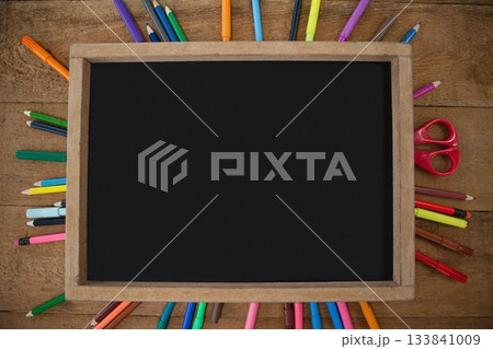 High angle view of empty chalkboard with colorful equipment High angle view of empty chalkboard with colorful equipment 133841009