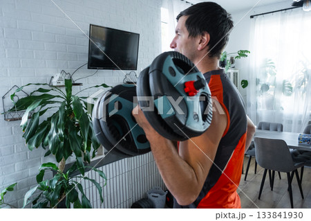 Strength training for men at home with dumbbells, biceps exercise with heavy weight 133841930