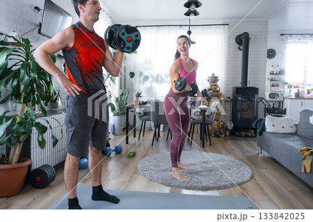Joint Strength training of husband and wife at home with dumbbells 133842025